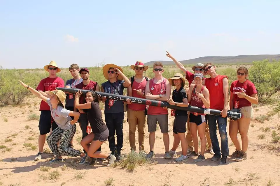 Photo of a group of students holding a rocket